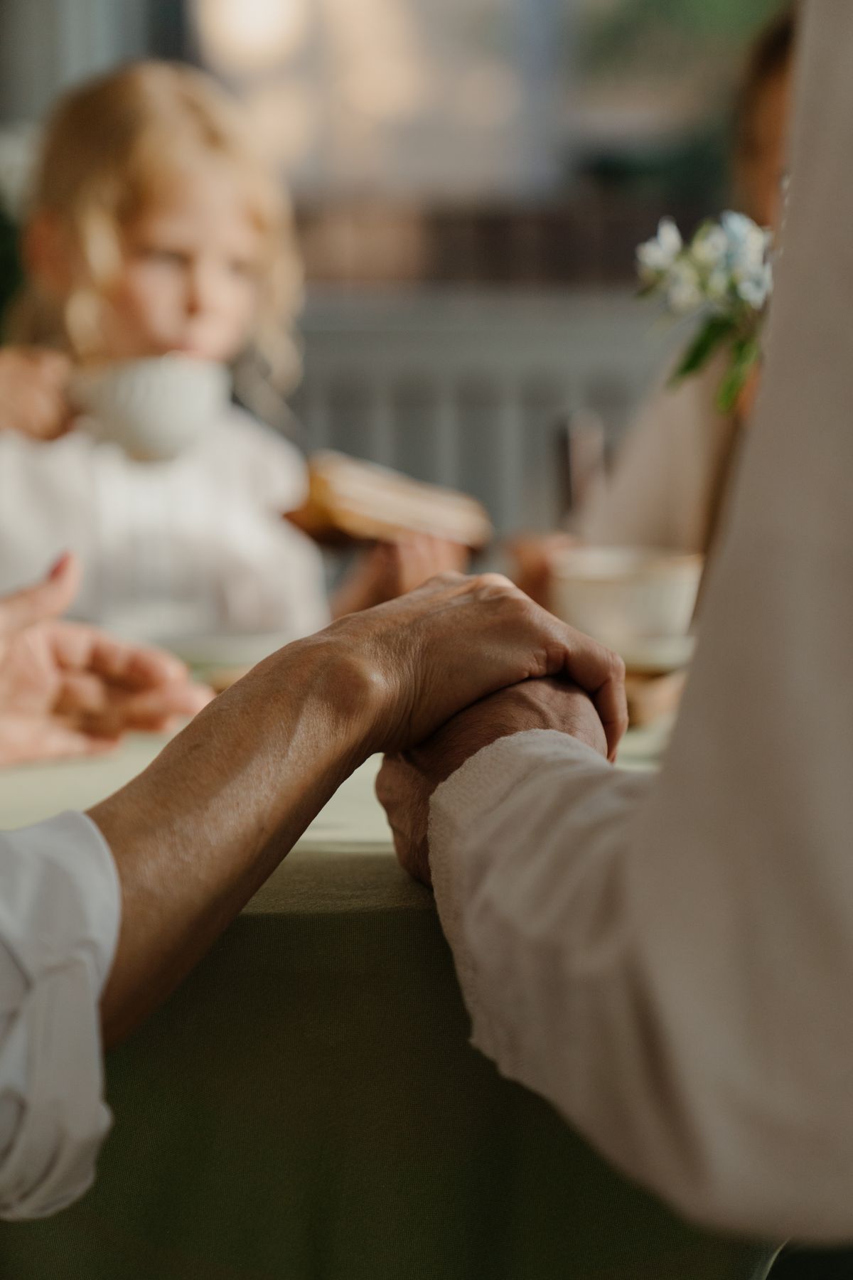 Three hands holding each other as a symbol of family support
